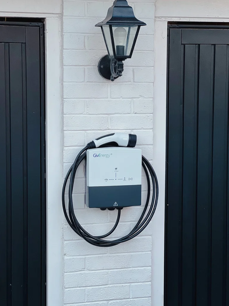 EV Charger installed next to garage doors in a home in Pirbright