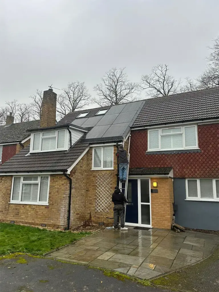 Solar panels on a roof with a cloudy sky